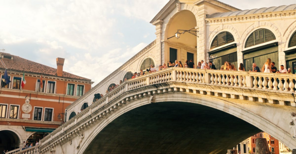 Iconic Rialto Bridge Spans Venetian Canal, Showcasing Renaissance Splendor